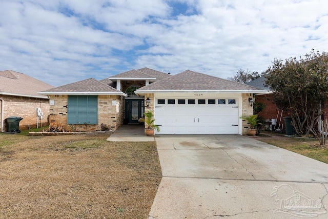 ranch-style house featuring a garage and a front yard