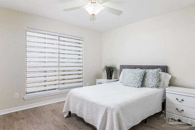 bedroom featuring hardwood / wood-style flooring and ceiling fan