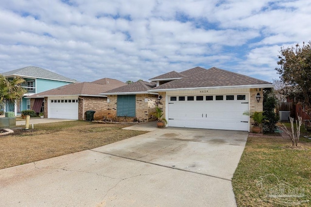 ranch-style home with a garage, central AC, and a front yard