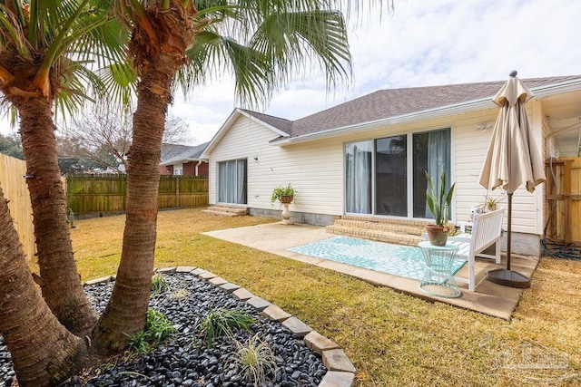 back of property with a patio and a yard