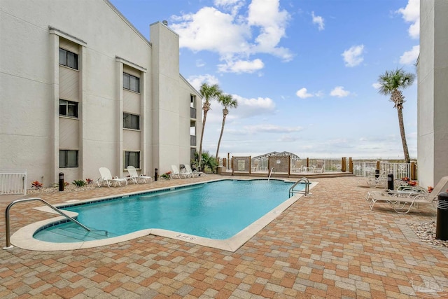 pool featuring a patio and fence