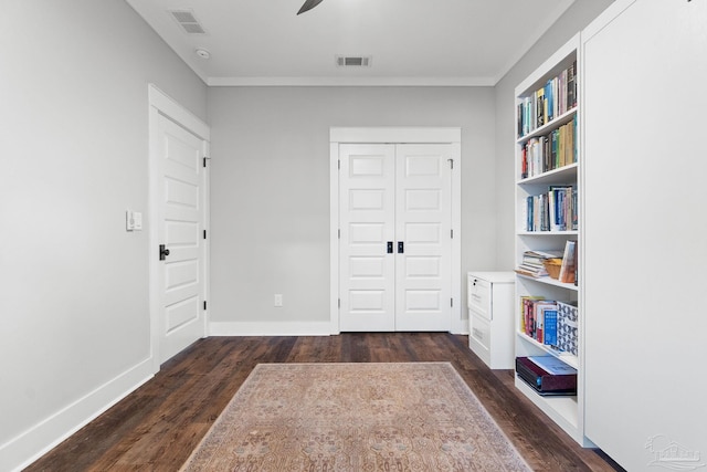 interior space featuring dark wood finished floors, visible vents, crown molding, and baseboards