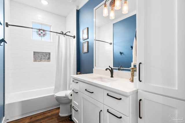 bathroom with shower / tub combo with curtain, wood finished floors, vanity, and toilet