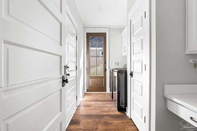 entryway featuring independent washer and dryer and dark wood finished floors