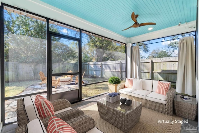 sunroom / solarium with a wealth of natural light and a ceiling fan