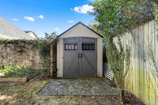 view of shed featuring a vegetable garden and a fenced backyard