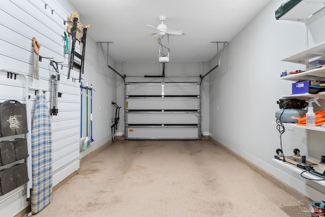 garage with a garage door opener and baseboards