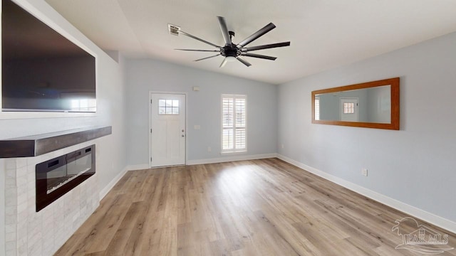 unfurnished living room with ceiling fan, light hardwood / wood-style floors, and lofted ceiling