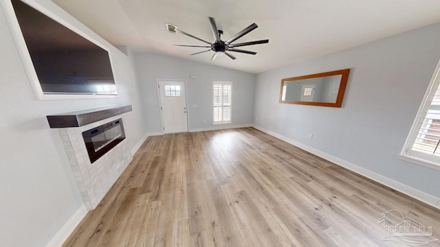 unfurnished living room featuring light hardwood / wood-style floors, lofted ceiling, and ceiling fan