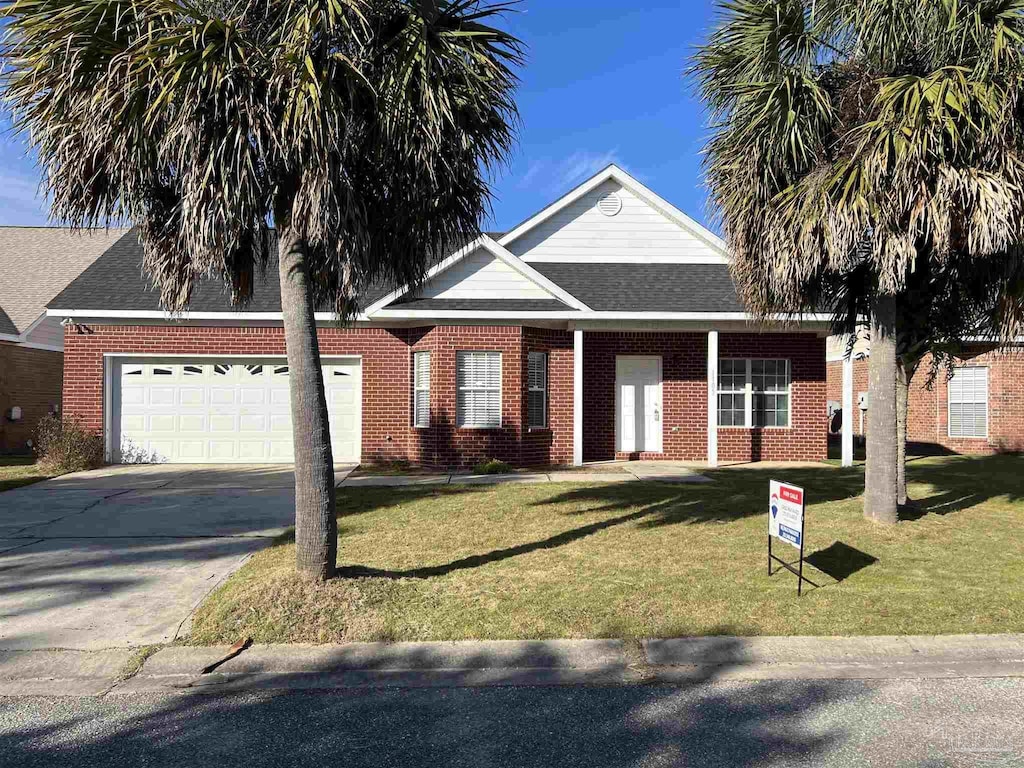 view of front facade featuring a front lawn and a garage