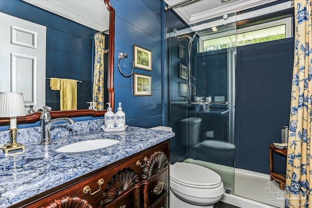 full bathroom featuring vanity, a shower stall, and toilet