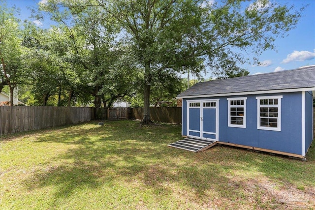 view of yard featuring an outdoor structure and a fenced backyard