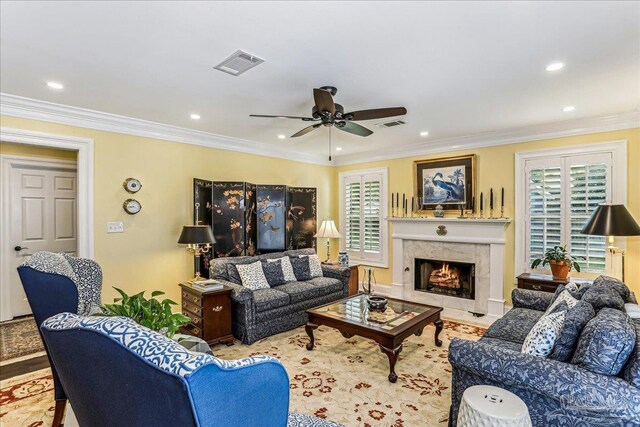 living area featuring ceiling fan, recessed lighting, visible vents, and a tiled fireplace