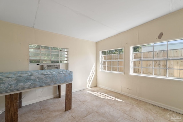 interior space featuring cooling unit, light tile patterned flooring, and lofted ceiling