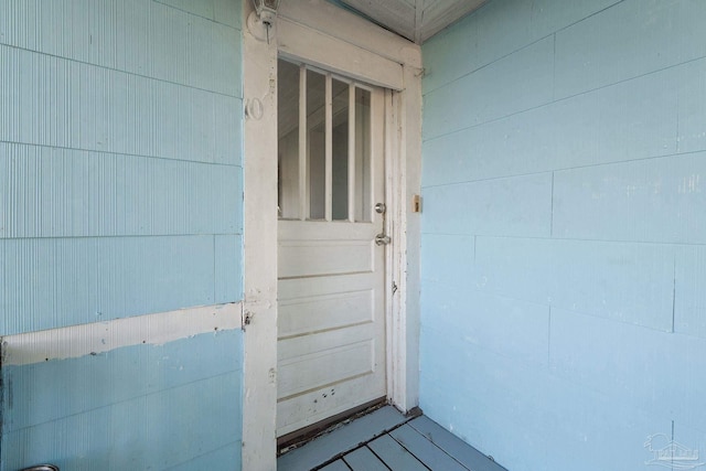 view of exterior entry featuring concrete block siding