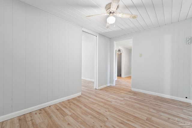 empty room with light wood-style floors, wooden ceiling, ceiling fan, and baseboards