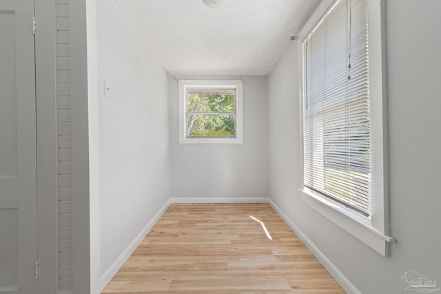 spare room with light wood finished floors and baseboards