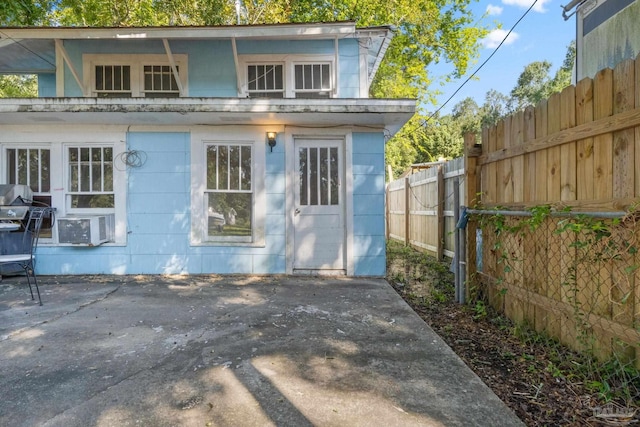 back of property with cooling unit and a patio