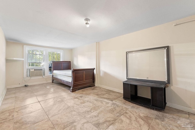 unfurnished bedroom featuring cooling unit and baseboards