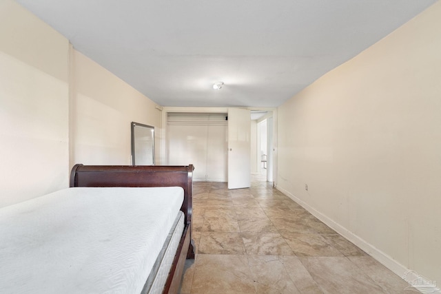 bedroom featuring a closet and baseboards