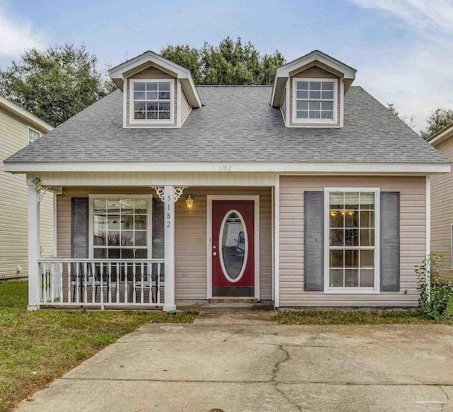 view of front of house with a porch and roof with shingles