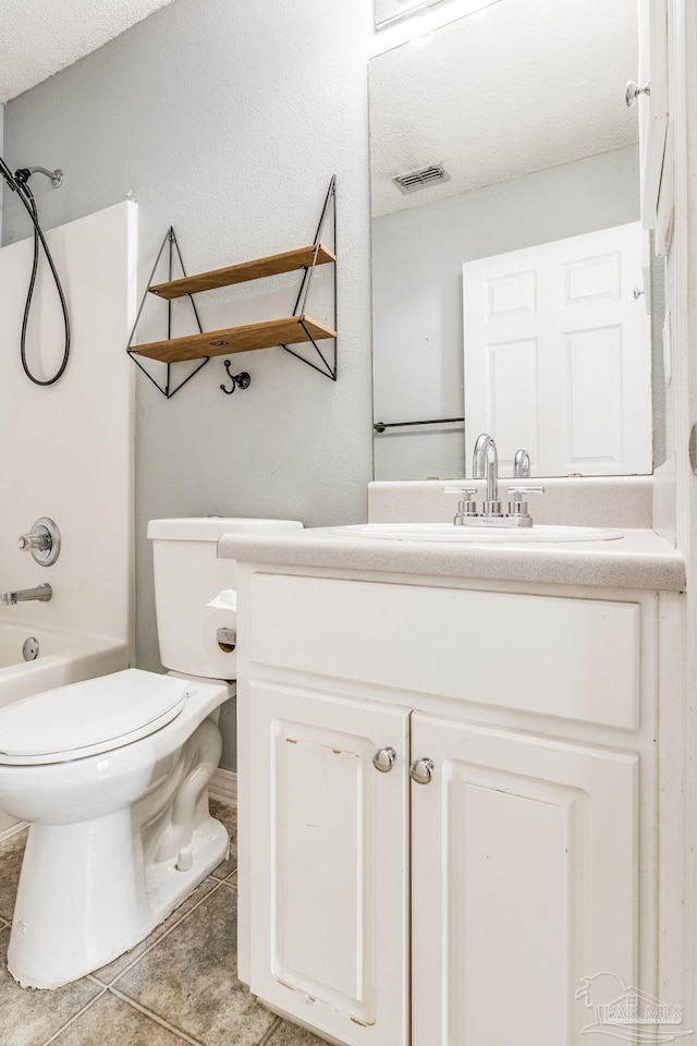 full bathroom featuring tile patterned flooring, bathing tub / shower combination, a textured ceiling, toilet, and vanity