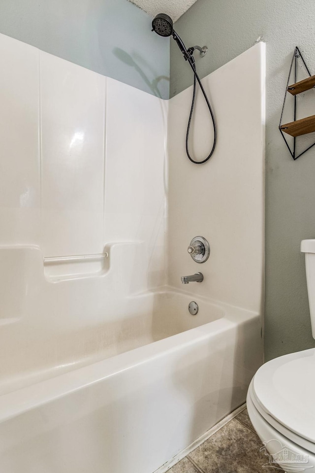 bathroom with shower / bath combination, toilet, and tile patterned flooring