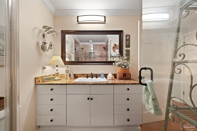 bathroom featuring an enclosed shower, crown molding, and vanity