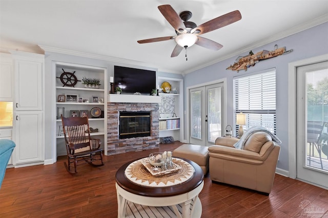 living room with ceiling fan, a stone fireplace, dark hardwood / wood-style flooring, and a healthy amount of sunlight