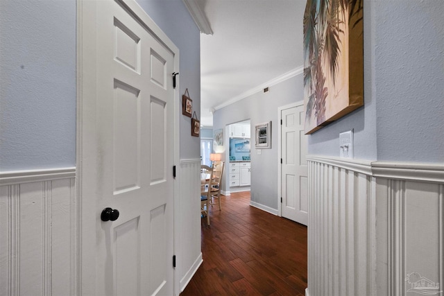 hall featuring ornamental molding and dark hardwood / wood-style flooring