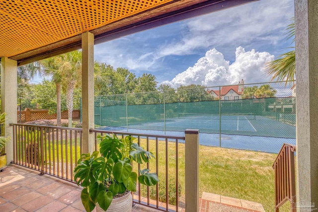 view of sport court featuring a lawn