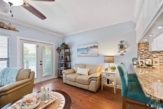 living room with hardwood / wood-style flooring, french doors, a healthy amount of sunlight, ceiling fan, and crown molding