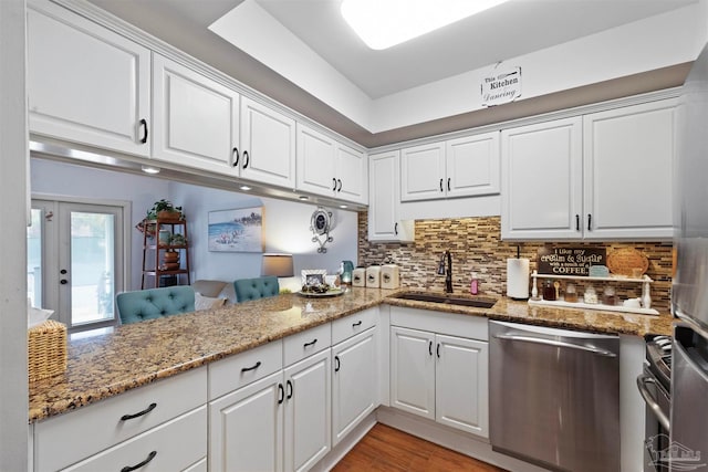 kitchen featuring white cabinetry, sink, decorative backsplash, and dishwasher