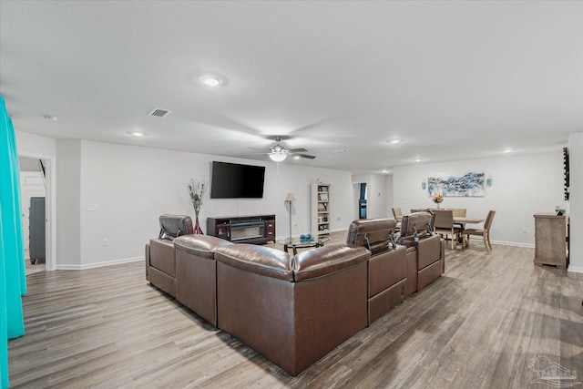 living room with ceiling fan and light hardwood / wood-style floors