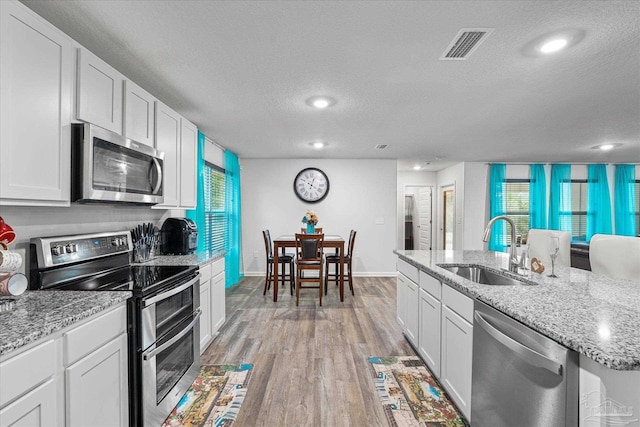 kitchen with white cabinets, sink, and stainless steel appliances