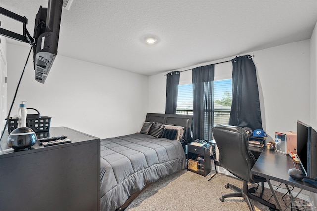 bedroom with carpet and a textured ceiling