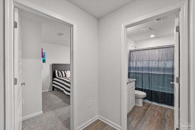 full bathroom featuring a textured ceiling, toilet, vanity, and shower / bathtub combination with curtain