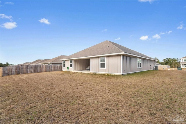 rear view of house featuring a patio area and a yard