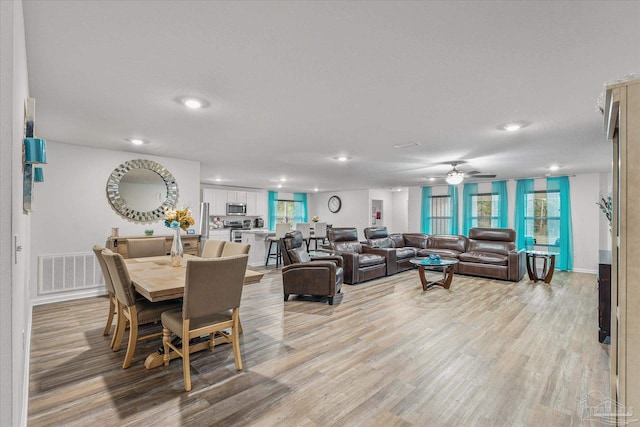 dining space featuring ceiling fan, a textured ceiling, and light hardwood / wood-style flooring