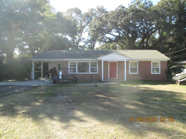 ranch-style home featuring a carport and a front yard