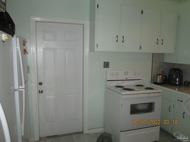 kitchen featuring white appliances and white cabinets