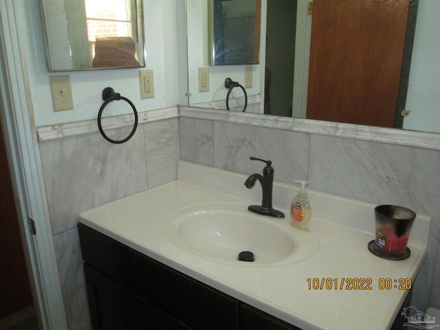 bathroom featuring vanity and tasteful backsplash