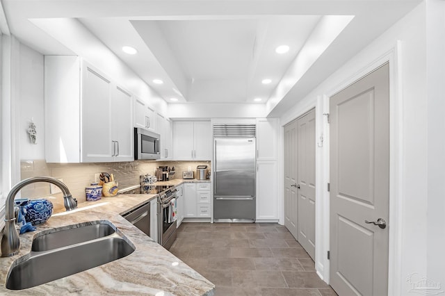 13335 Johnson Beach Rd Unit 1003, Pensacola, FL 32507 - kitchen with sink, appliances with stainless steel finishes, white cabinets, and a tray ceiling