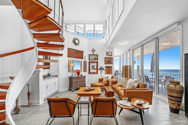 13335 Johnson Beach Rd Unit 1003, Pensacola, FL 32507 - living room featuring a high ceiling, expansive windows, a water view, and light tile patterned floors