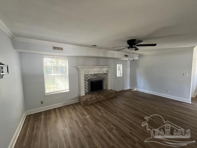 living room with a fireplace, ceiling fan, ornamental molding, and dark hardwood / wood-style floors