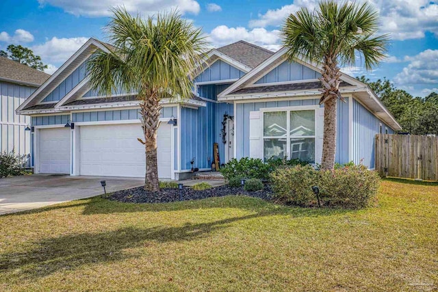 view of front of home featuring a front lawn and a garage