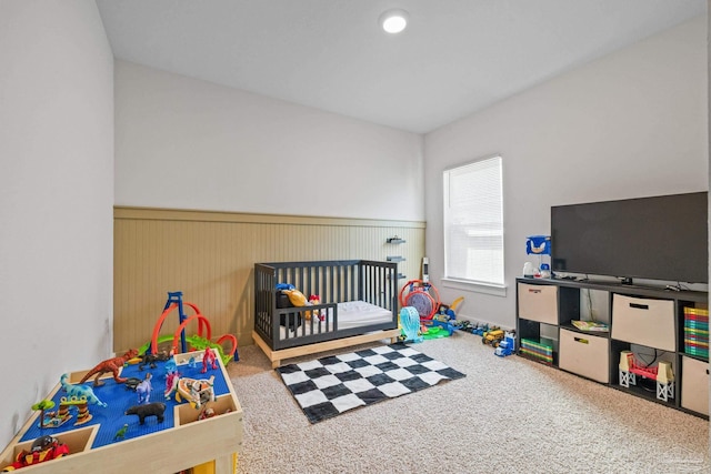 carpeted bedroom with a crib