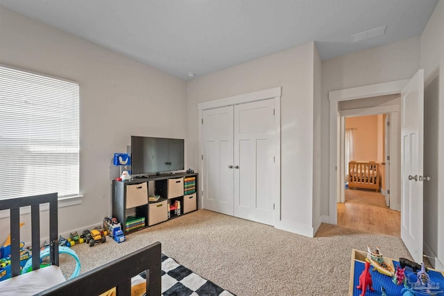 carpeted bedroom with a closet