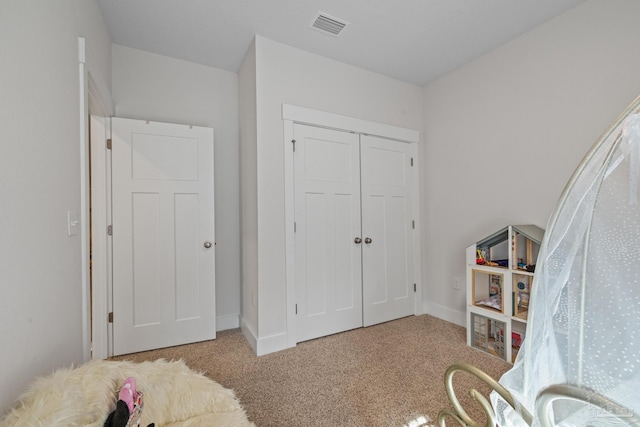 carpeted bedroom featuring a closet