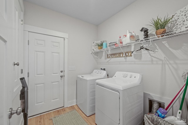 washroom featuring separate washer and dryer and light hardwood / wood-style flooring